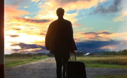 Pulling suitcase into sunset