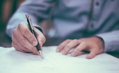 Boss holding pen and writing